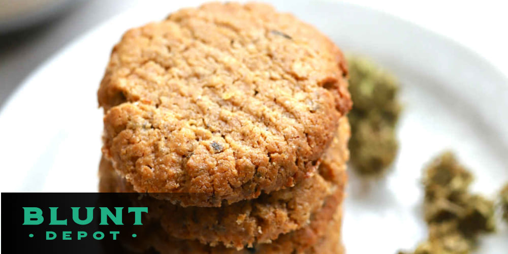 Golden brown cannabis-infused mini cookies on a rustic wooden table.