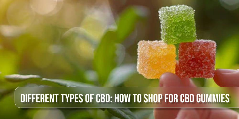 CBD gummies placed on a wooden surface with fresh hemp leaves in the background.