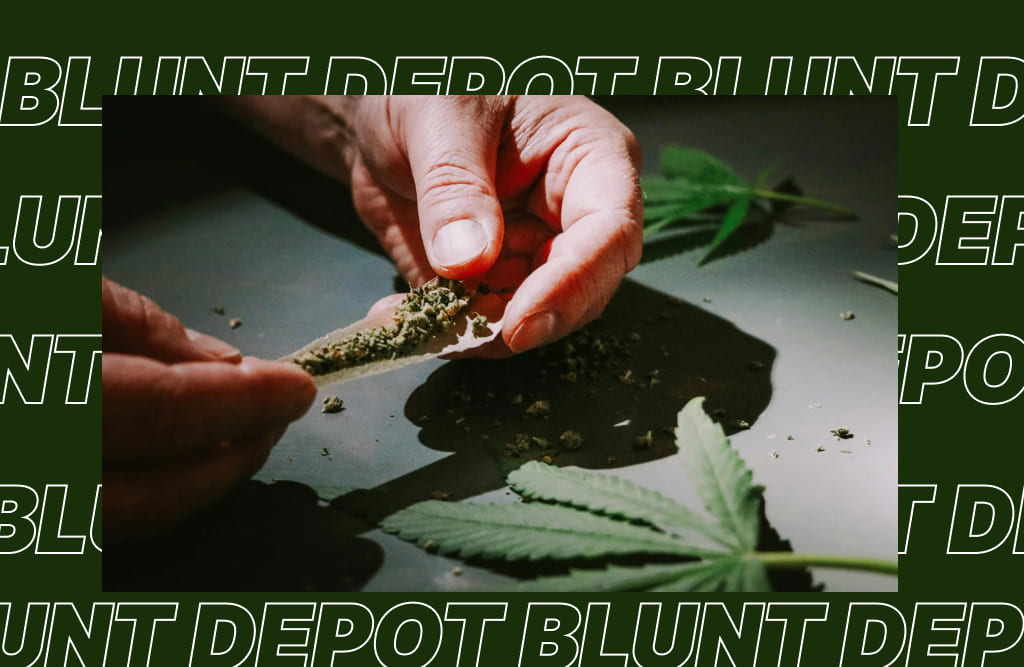 Hands rolling a joint with THCA flower, with cannabis leaves on a dark surface and repeating "BLUNT DEPOT" logo in the background.