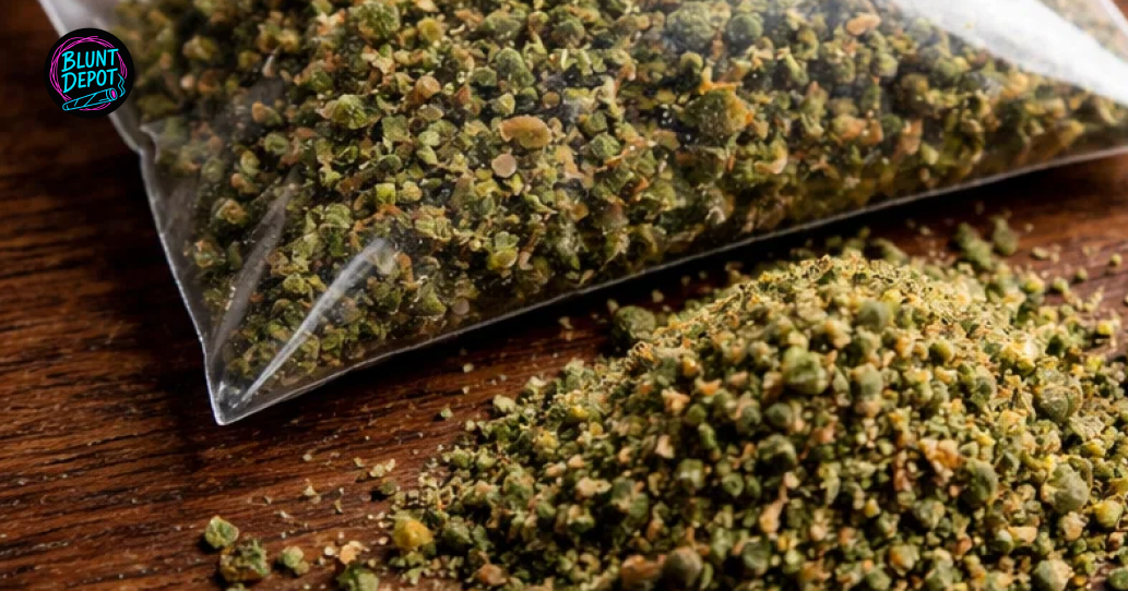 A silver spoon holding a pile of blonde cannabis kief collected from the resin-rich HeadBang weed strain.